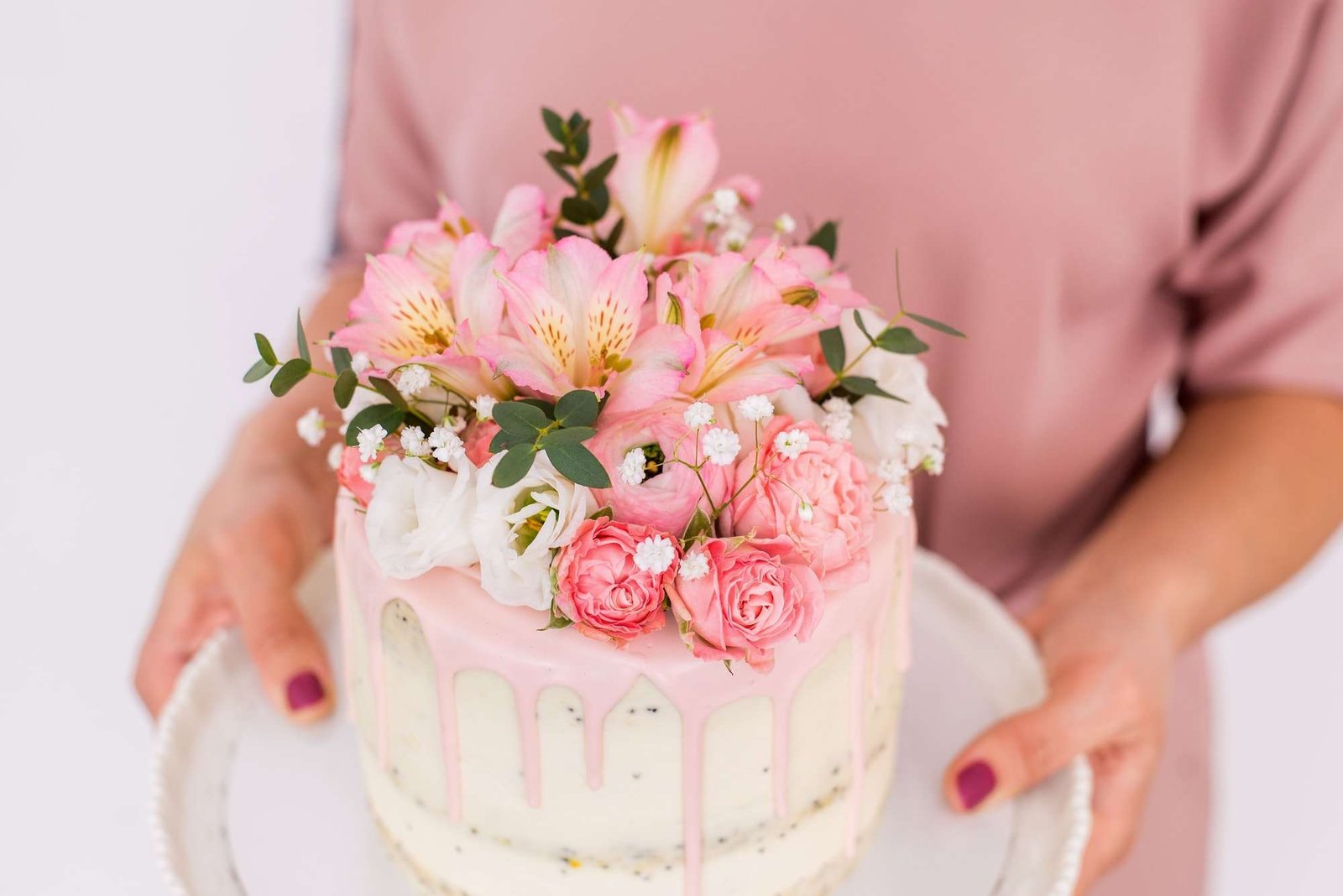 a pink cake with flowers on top