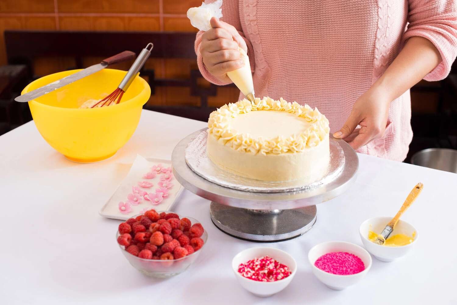 a person decorating a cake