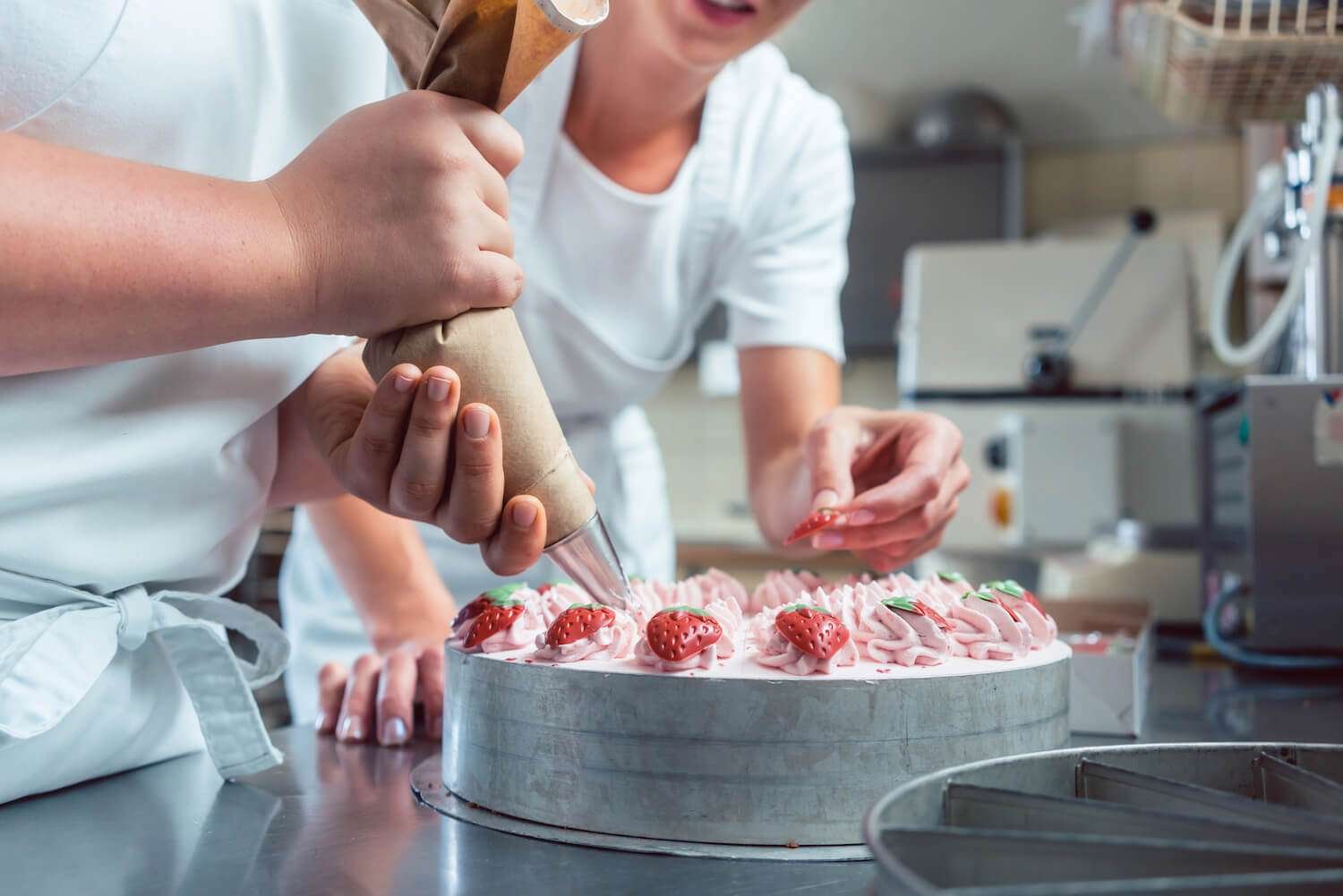 a woman decorating a cake