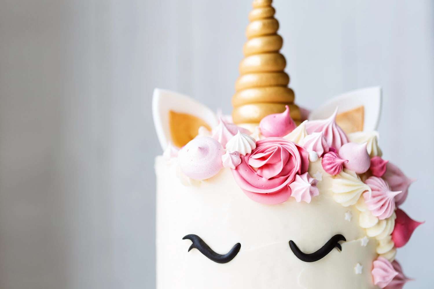 a cake with a unicorn horn and flowers