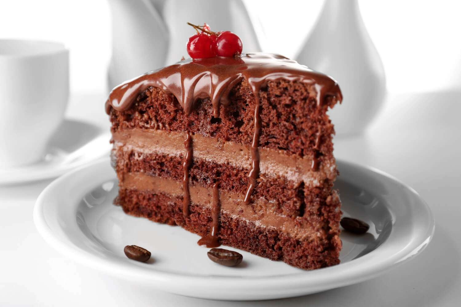 a piece of chocolate cake with a red berry on top