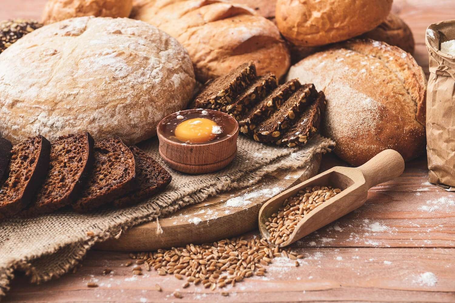 a group of breads on a wood surface
