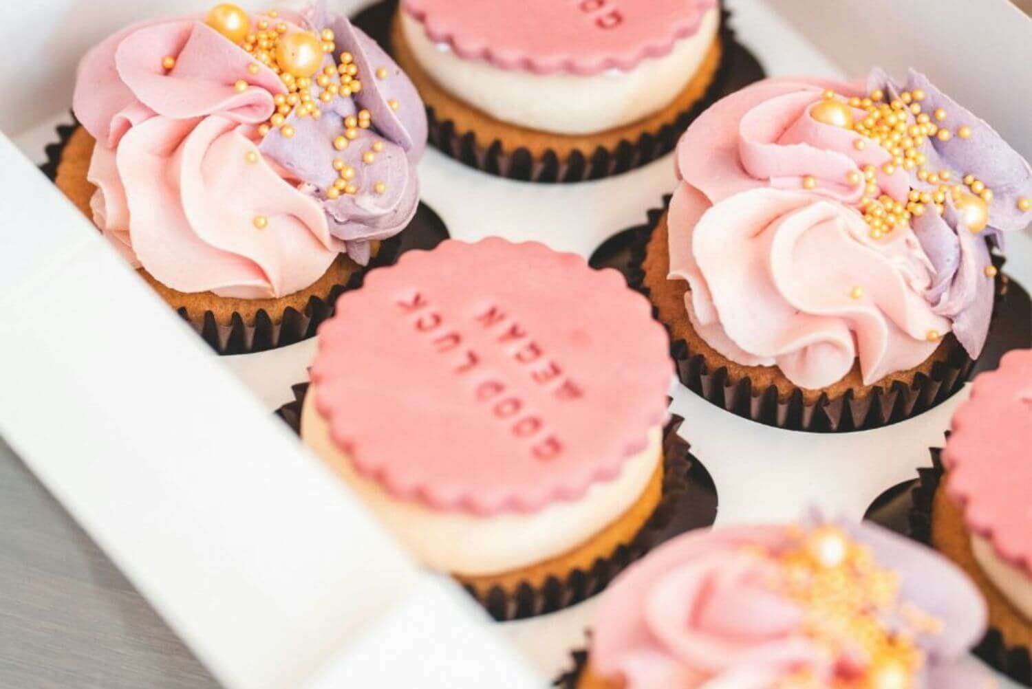 a box of cupcakes with frosting